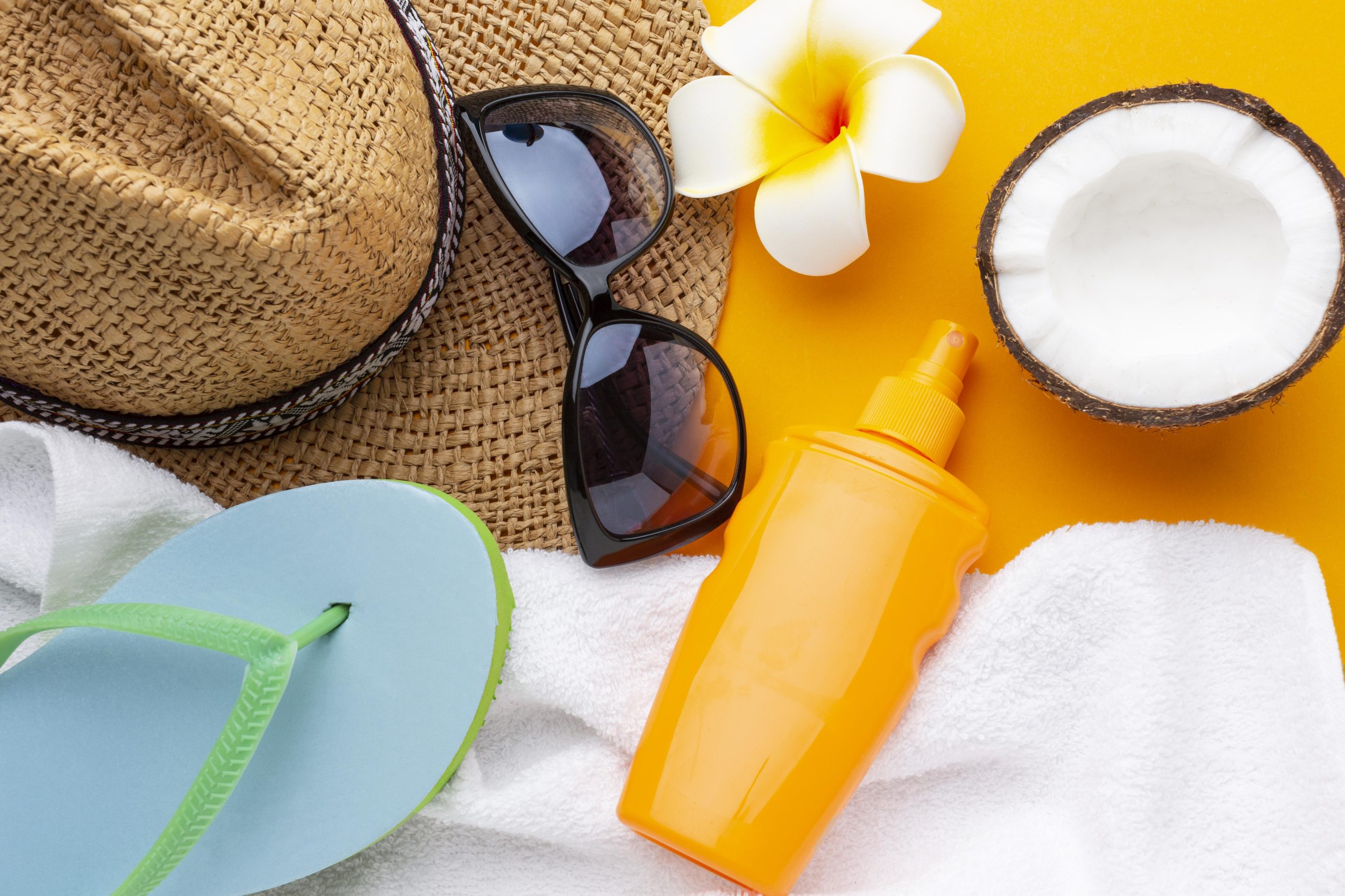 travel-items-yellow-background-top-view
